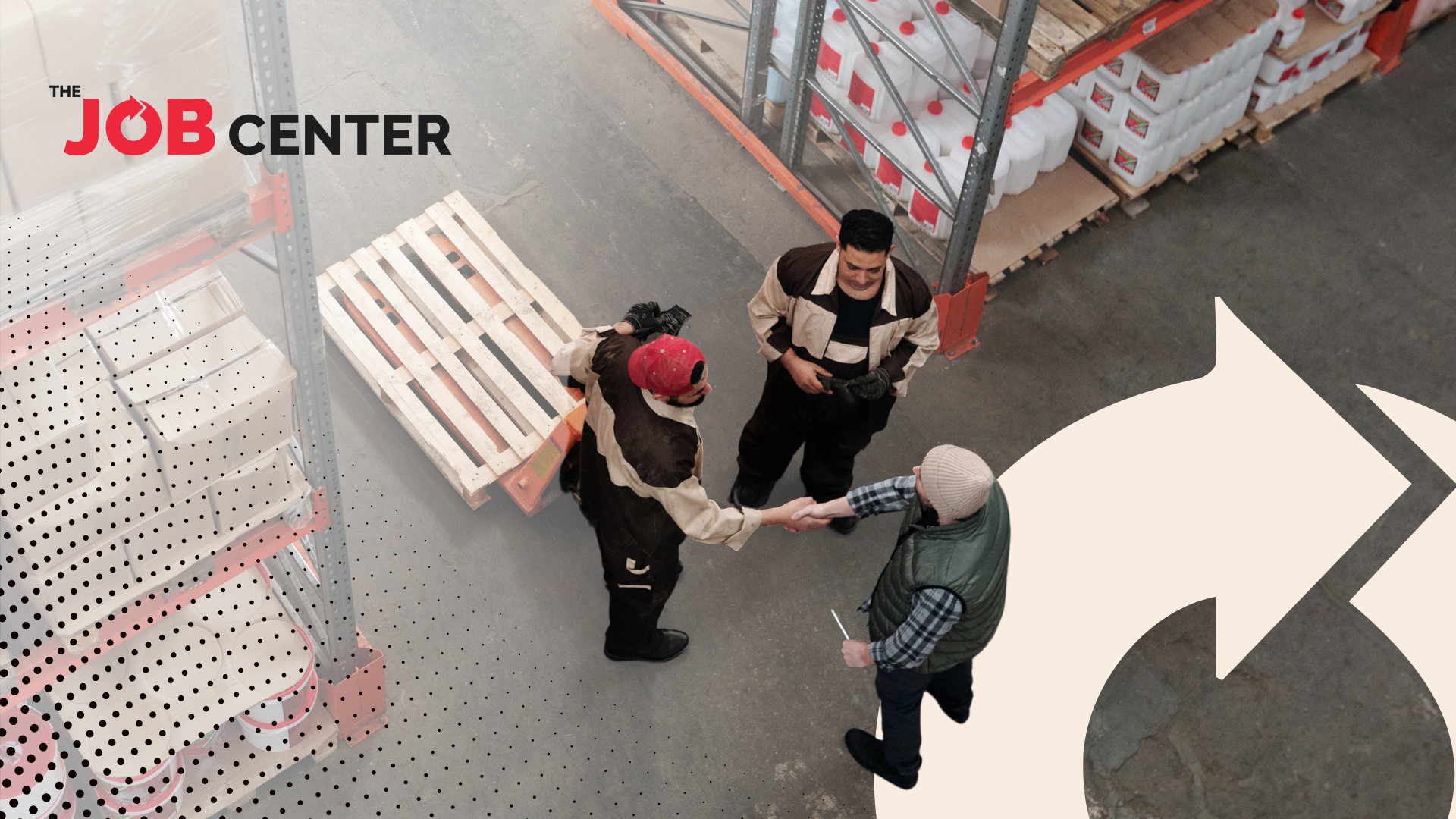Three warehouse workers stand in a circle, two shaking hands